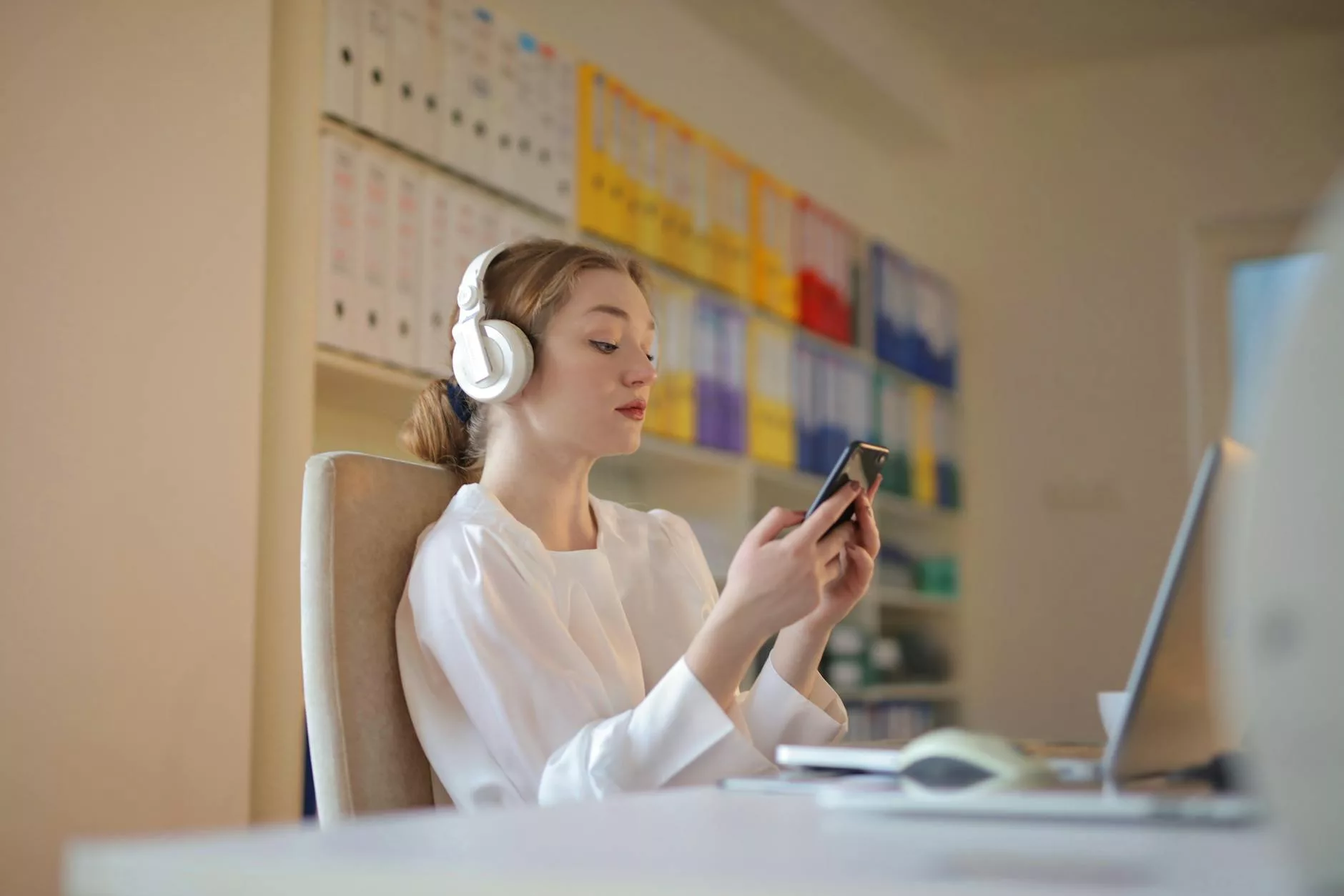 woman n white long sleeve using smartphone